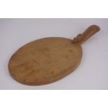 'Mouseman' oval cheese board handle, by Robert Thompson of Kilburn,