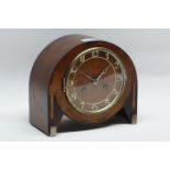Art Deco period mantle clock in walnut inlaid banded cased with silvered feet,