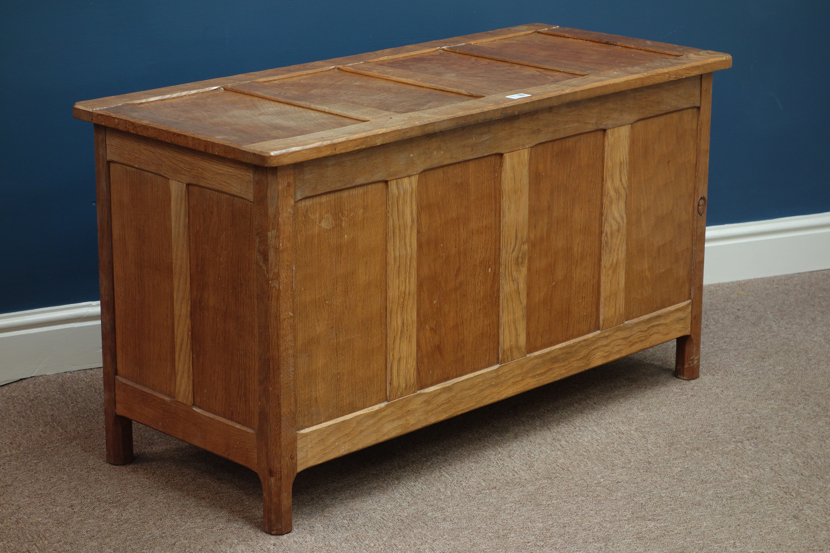 'Acornman' adzed oak four panelled blanket box, with hinged lid, by Alan Granger of Brandsby,