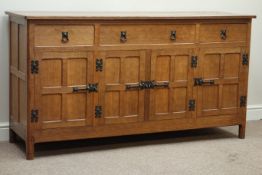 'Acornman' adzed oak sideboard, three drawers, enclosed by four adzed panelled doors, iron fixtures,