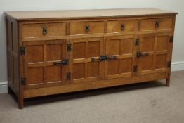 'Acornman' adzed oak sideboard, four drawers, enclosed by four adzed panelled doors, iron fixtures,