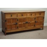 'Acornman' adzed oak sideboard, four drawers, enclosed by four adzed panelled doors, iron fixtures,