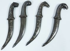 Group of four Turkmenistan miniature 'Jambiyas' with various pommel designs and matching scabbards