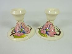 Pair of Moorcroft cream ground Clematis pattern candlesticks (2) Condition Report