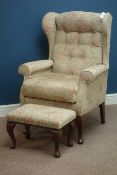 Wingback armchair with matching stool upholstered in floral fabric