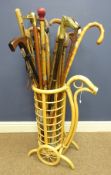 Collection of various walking sticks in a cane stick stand Condition Report <a