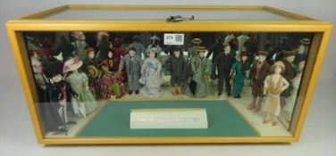 '100 years of fashion' dolls in glazed display case,