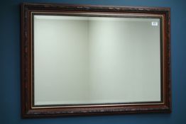 Large rectangular red and gilt framed bevel edged mirror (129cm x 98cm),
