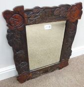 Earl 20th Century bevelled glass mirror in carved wood frame,