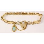 Hallmarked 9ct gold three bar fancy gate bracelet with opal charm and heart lock 10.