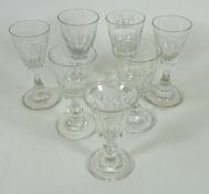 Four 19th Century similar cut glass wine glasses,