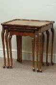 Reproduction walnut nest of three tables, shaped quarter veneers tops,