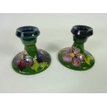 Pair of Moorcroft green ground Pansy pattern candlesticks (2) Condition Report The