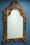 Ornate wall mirror in gilt frame with shaped top, W90cm,