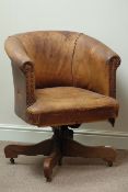 Early 20th century oak framed tub shaped swivel office chair, upholstered in antique leather,