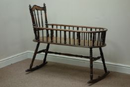 Victorian oak rocking cot, turned base, with ribbon carving to top rail,