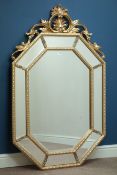 Octagonal wall mirror in gilt frame with sectional mirrored border and ornate pediment, W88cm,