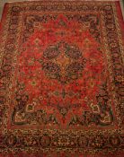 Large Persian Meshed rug carpet, decorated with urn motifs, large centre blue rosette,