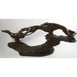 Cast bronze sculpture of three greyhounds running at speed, on naturalistic base and oval plinth,