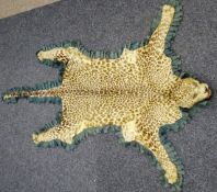 Taxidermy - early 20th century felt backed leopard skin rug with snarling head,