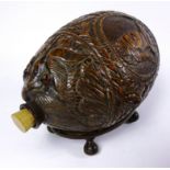 19th century bug bear flask carved with Balkan figures, a wolf and leafage with glass eyes,