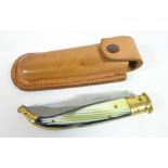 Folding knife with brass and horn type handle, steel blade engraved Albacete, in leather sheath,