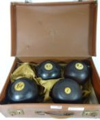 Set of four early 20th Century Lignum Vitae bowling balls with ivory inlay Condition