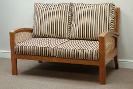 Walnut framed two seat bergere sofa with loose cushions upholstered in striped fabric,