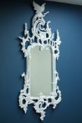 Ornate hand carved wood wall mirror with pierced decoration and bird pediment, bevelled glass,