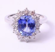 White gold cluster ring set with a long cushion cut Ceylon sapphire of 2.
