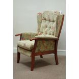 Stained beech framed high seat armchair upholstered in floral pattern fabric Condition