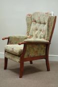 Stained beech framed high seat armchair upholstered in floral pattern fabric Condition