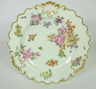 18th Century Chelsea hand painted plate with floral decoration and gilt moulded scrolls,