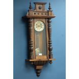 Early 20th century walnut Vienna clock, twin train movement striking the hours on a gong,