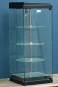 Glazed display cabinet with three revolving circular tiers and mirror base, W31cm, H76cm,