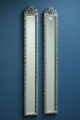 Pair narrow bevelled edge wall mirrors in silvered frame with ornate pediments,