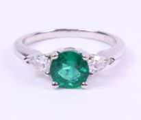 White gold ring set with a round cut emerald of approx 1.