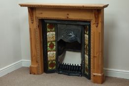Late 19th century cast iron tiled fire inset, with pine surround, W130cm,