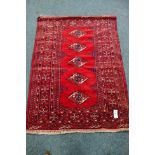 Persian Bokhara red and blue ground rug,