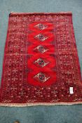 Persian Bokhara red and blue ground rug,