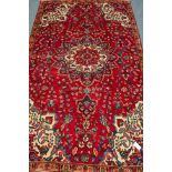 Persian Tabriz red ground rug, large central medallion,