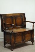 Early 20th century medium oak monks bench, hinged seat, bobbin turned supports,