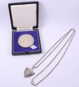 Hallmarked silver medal 'Incorporated Society of Valuers & Auctioneers' and a hallmarked silver fob