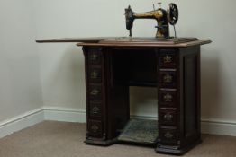 Singer treadle sewing machine in walnut case, five drawers with sewing equipment, W87cm, H79cm,
