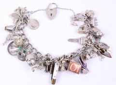 Charm bracelet with multiple charms some hallmarked some stamped silver Condition Report