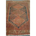 Antique Persian Shiraz rug, three diamonds within large blue ground lozenge,