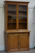 Edwardian walnut bookcase on cupboard,