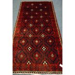 Persian red and blue ground rug, repeating motif design,