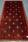 Persian red and blue ground rug, repeating motif design,