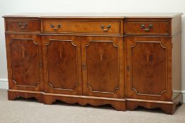 Reproduction yew wood break front sideboard, three drawers above four cupboard doors, W181cm, H91cm,
